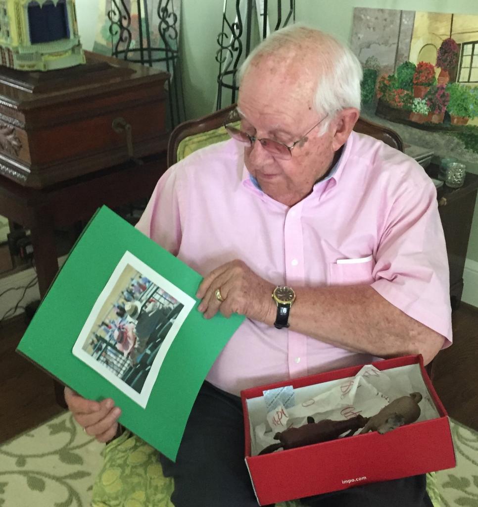 Poole opening the Derby book that explained his gift. (Kathy Smith photo)